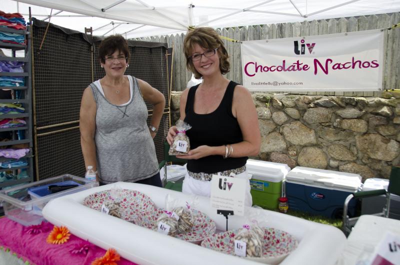 Rochester resident and entrepreneur Sara Mydlack, right, with her sister Mary Redman sold chocolate nachos, stored in ice chests to prevent melting in the heat. BY GEORGIA SPARLING